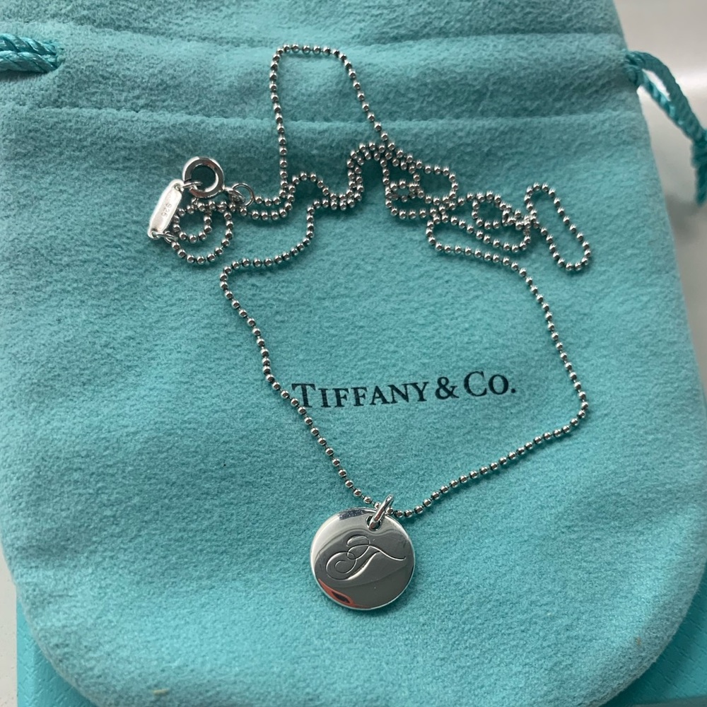 A beautiful Tiffany&Co sterling silver necklace with the letter T on a disc.